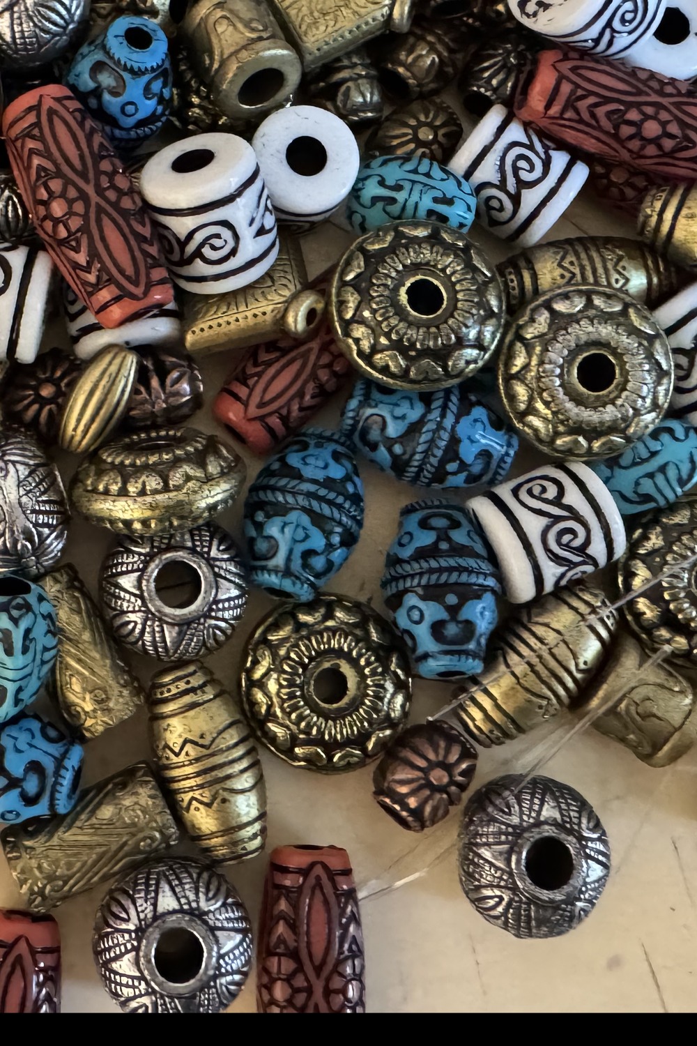 A pile of antique pattern beads in turquoise, terracotta, gold and silver — from Bonnie's collection.