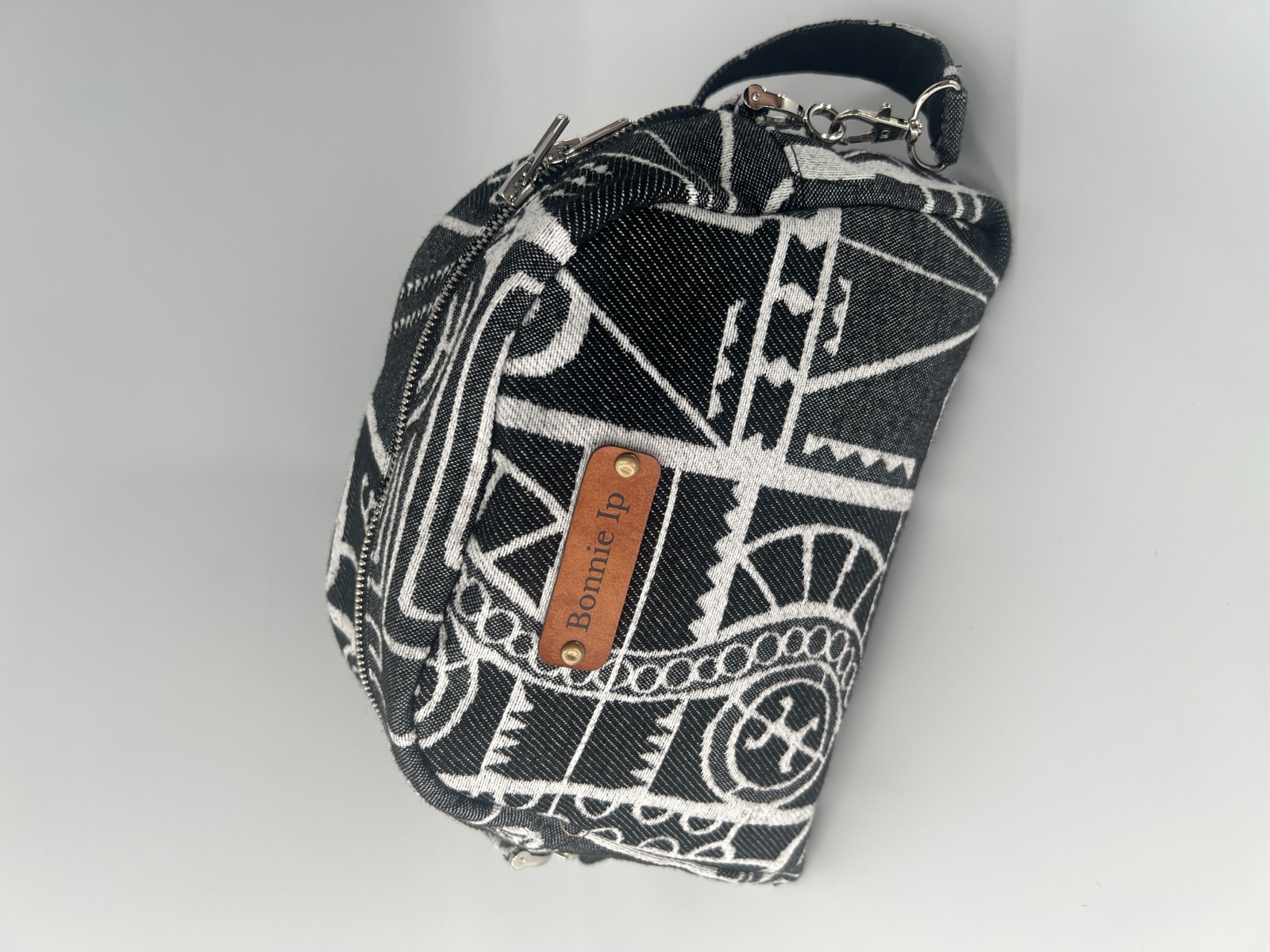 Black and white jacquard crossbody with a cognac leather Bonnie Ip tag.